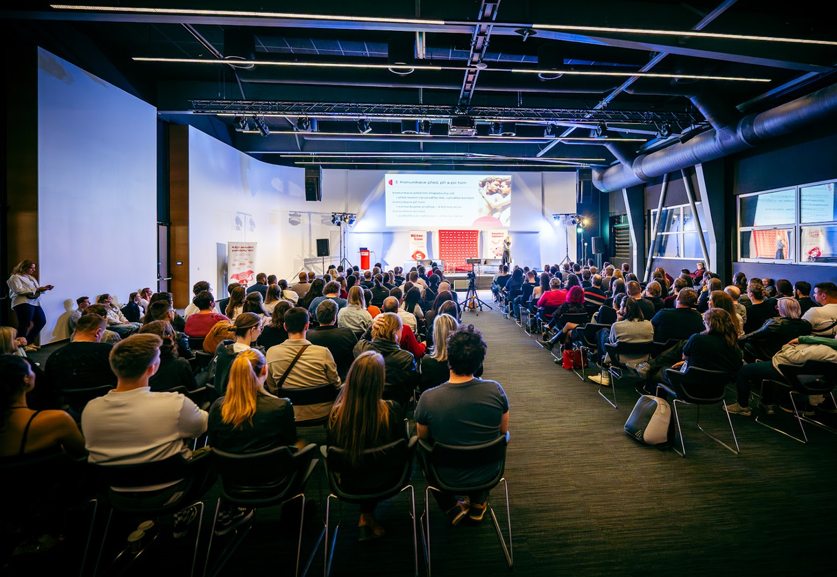 A speaker with a microphone during a talk in the fair's education zone